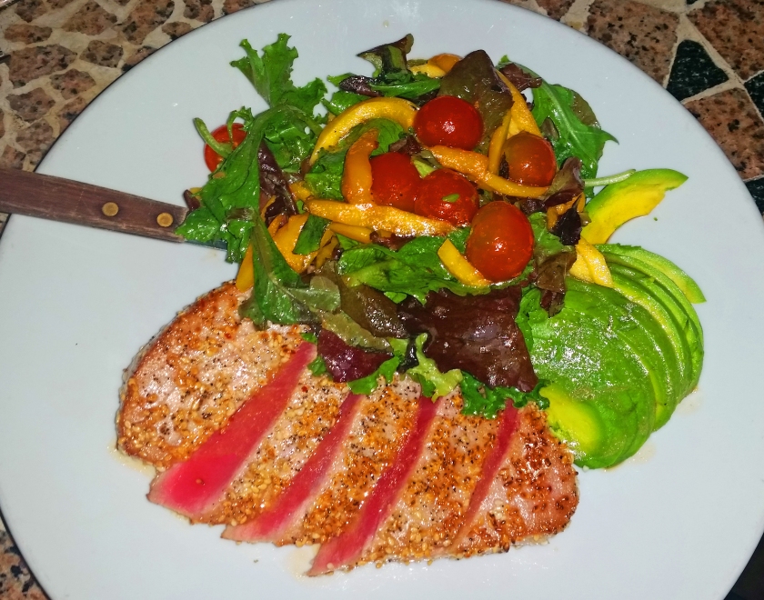 Sesame-encrusted tuna cooked medium rare. Side salad of mango, tomatoes, avocado and mixed greens. It's better than it looks.